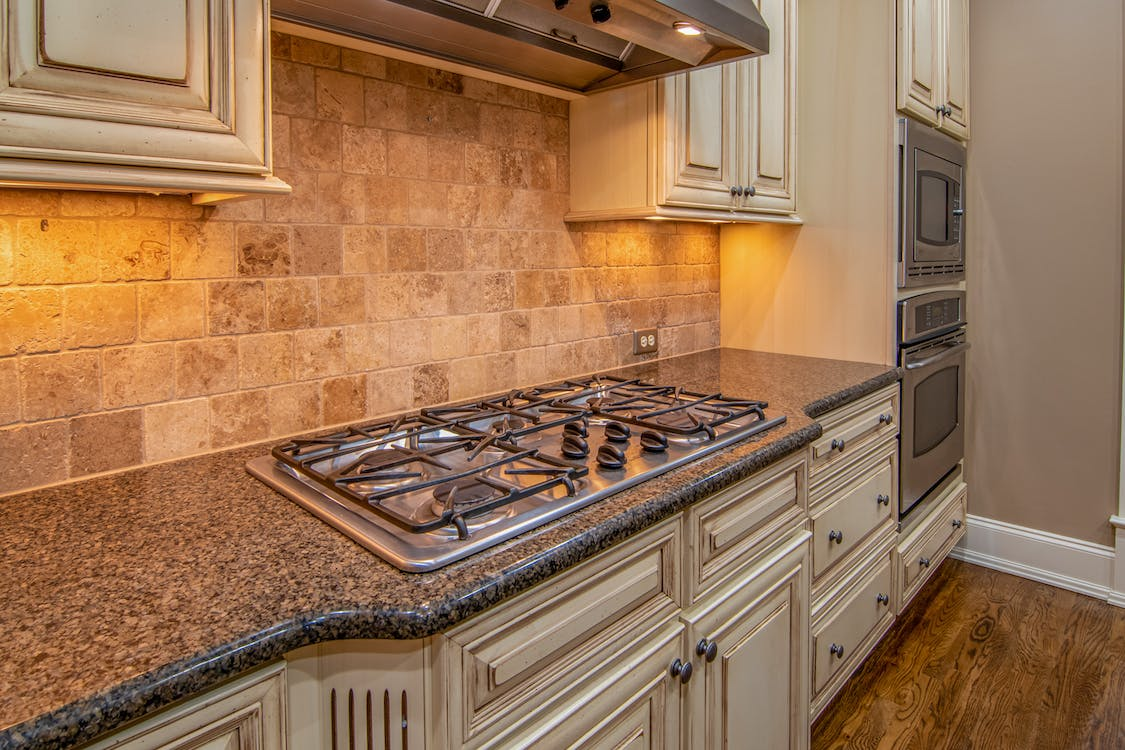 Oak cabinetry with granite countertop in kitchen