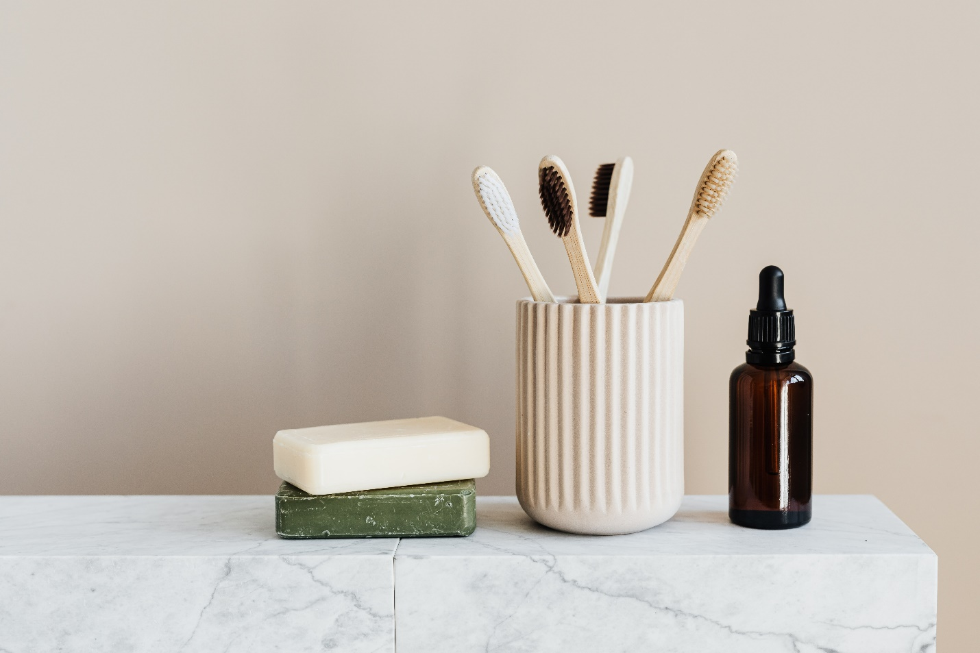 A set of bathroom toiletries sitting on a marble countertop
