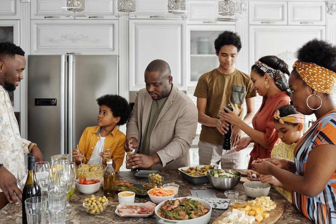 Family preparing food on the kitchen countertop