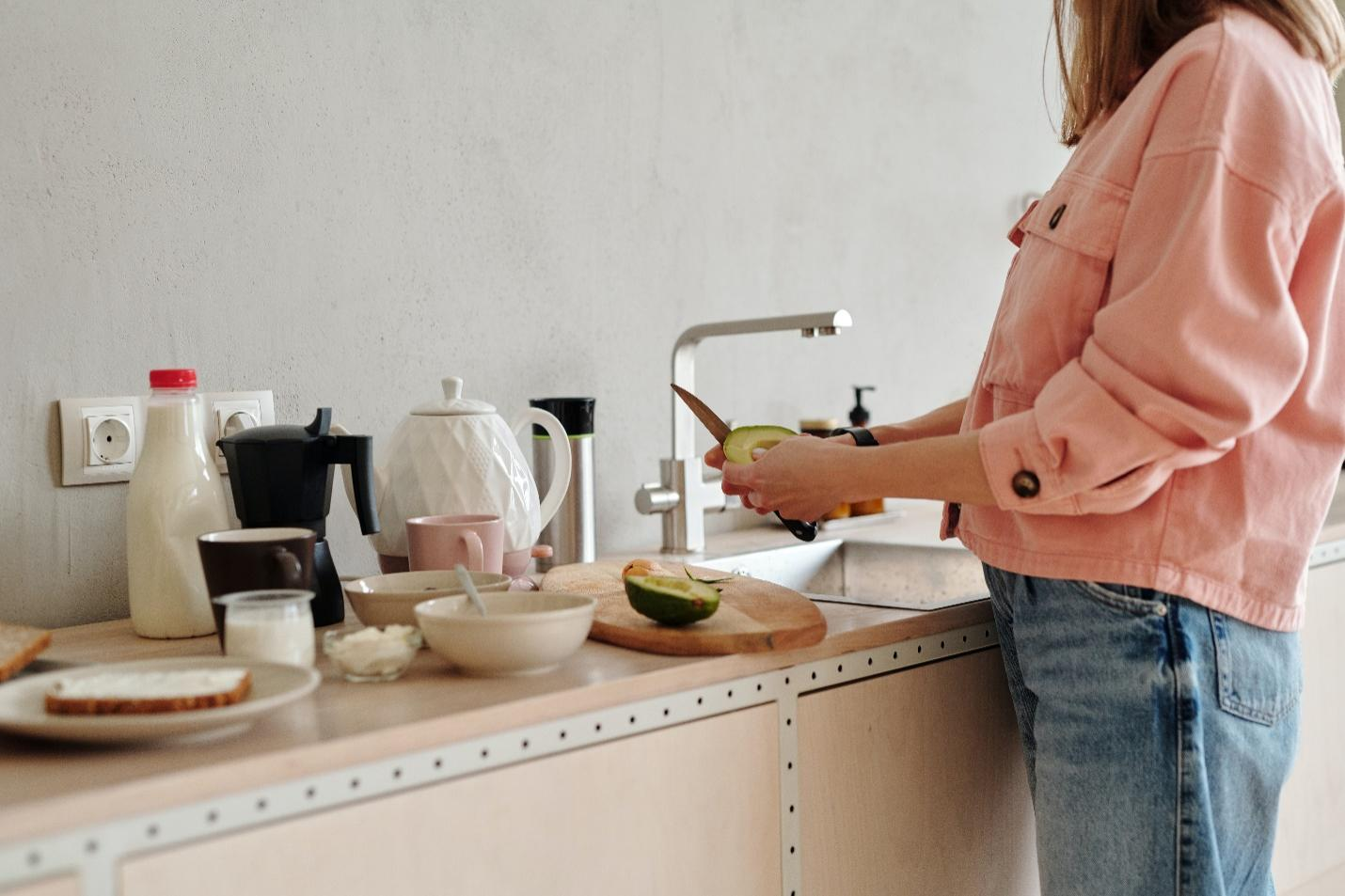 A woman enjoys creating meals on her durable quartz kitchen top