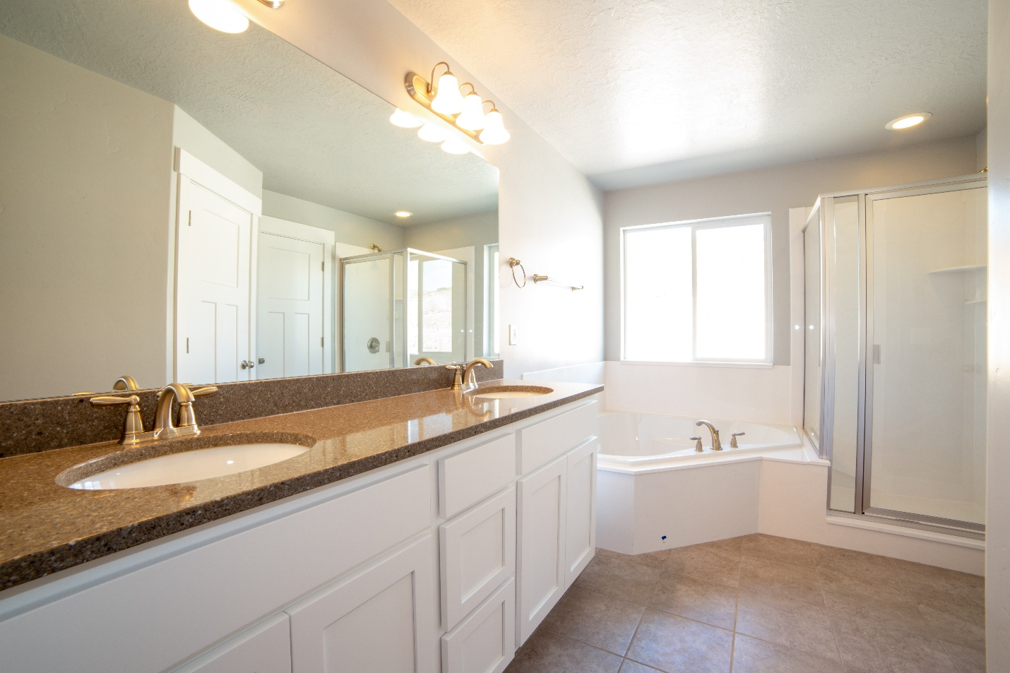 brown-colored marble bathroom countertop with white cabinets at the bottom