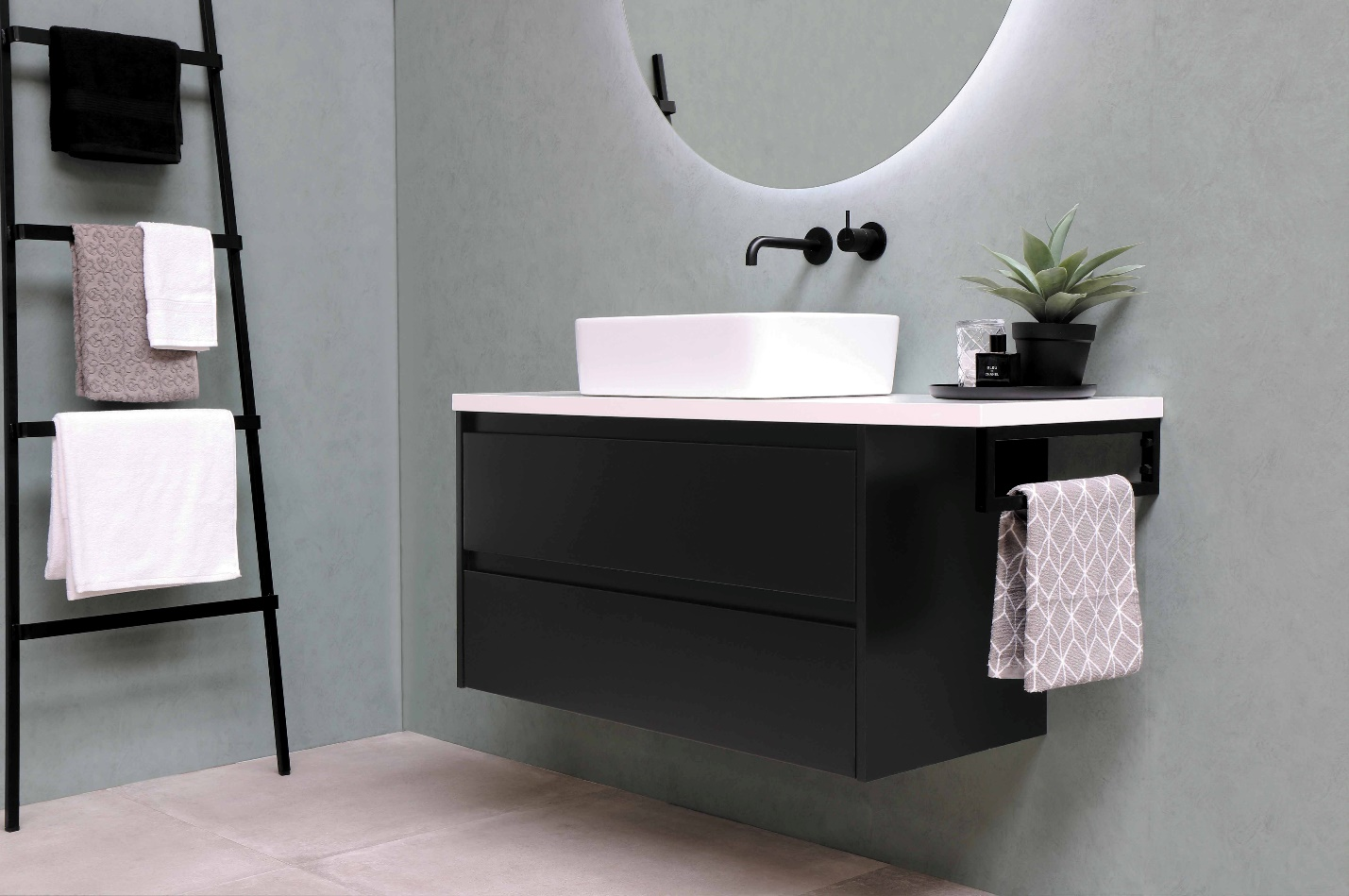 A modern bathroom with a white marble countertop and contrasting black storage