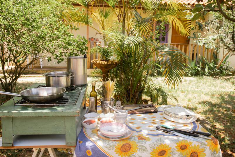 A dining table and stove in a backyard