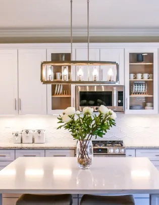 Two-tone countertop with beige marble in a classic kitchen design.