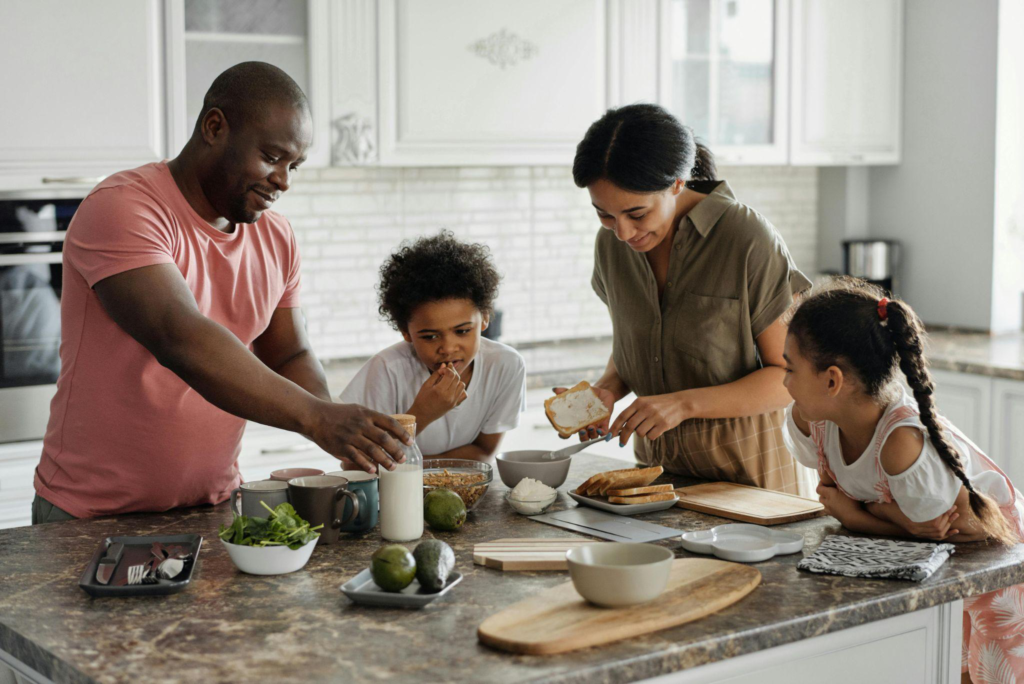 Family cooking together in the kitchen, highlighting a warm and inviting atmosphere.