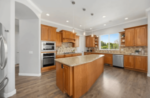A kitchen island features a light-colored countertop with subtle variations in tone