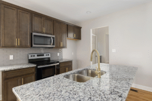 Marble kitchen countertop with golden faucet and twin sink